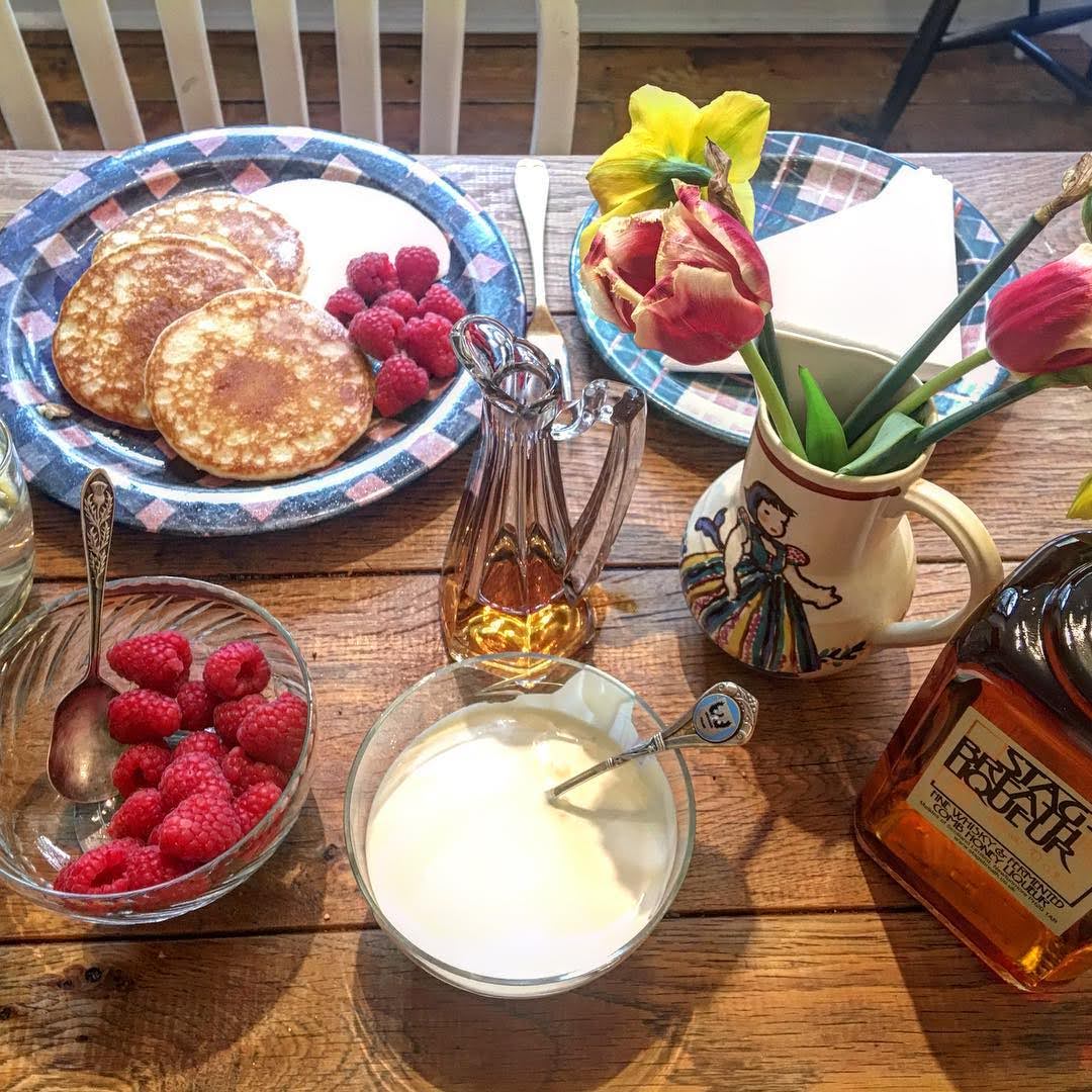 Pancake breakfast with Scottish raspberries, yoghurt, honey and whisky liqueur